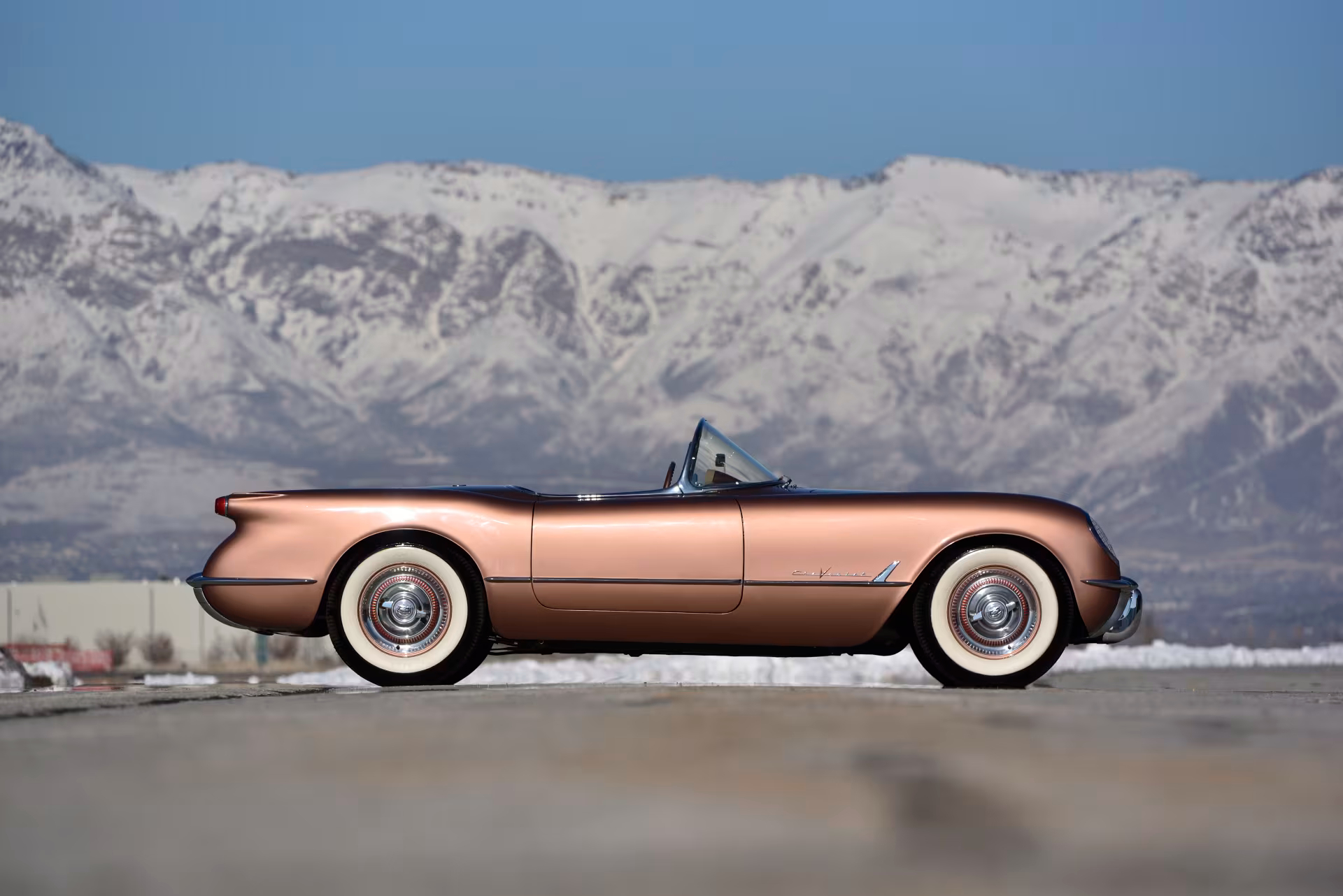 Side profile of a brown 1955 Chevrolet C1 Corvette