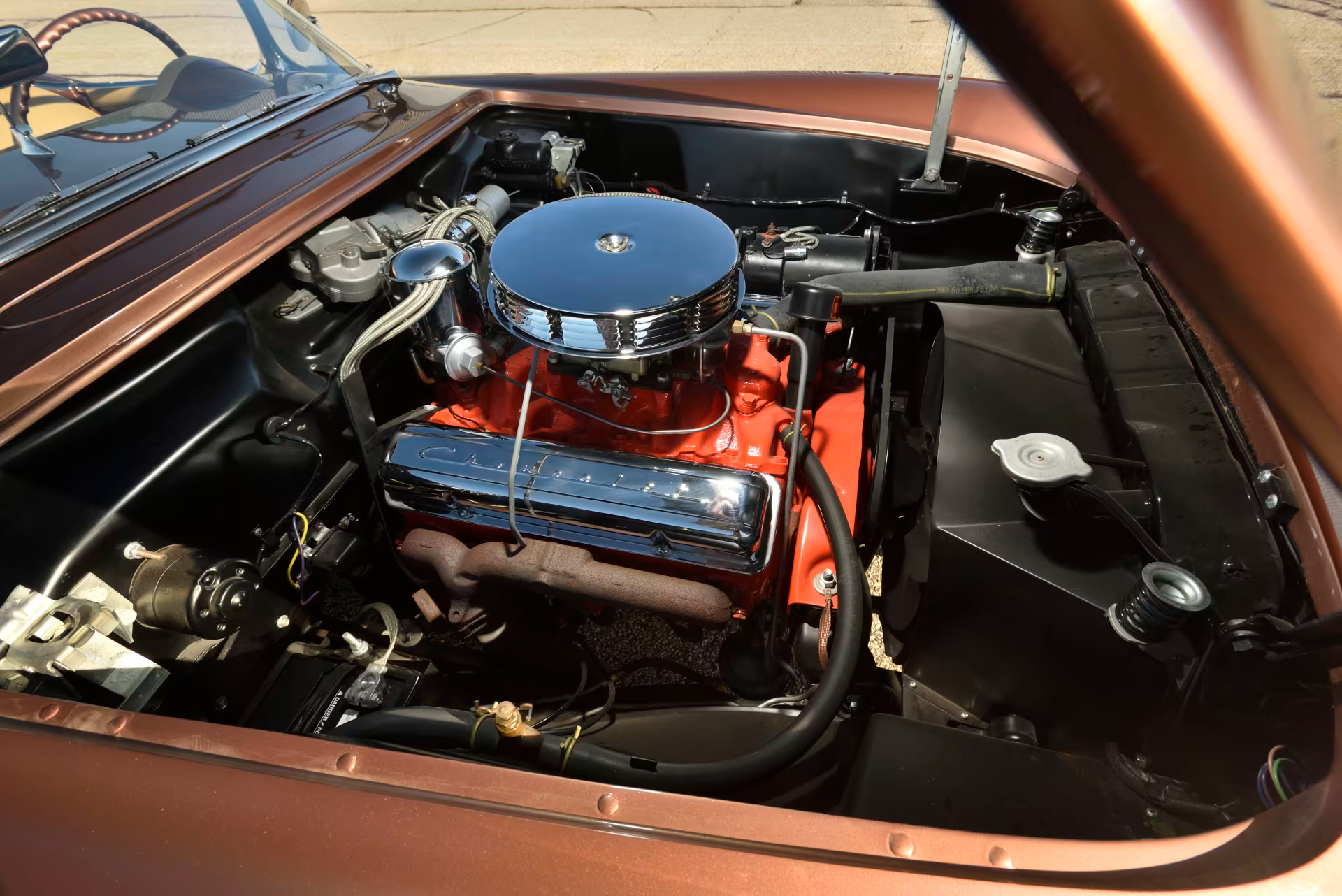 Image showing the V8 engine inside a brown 1955 Chevrolet Corvette.