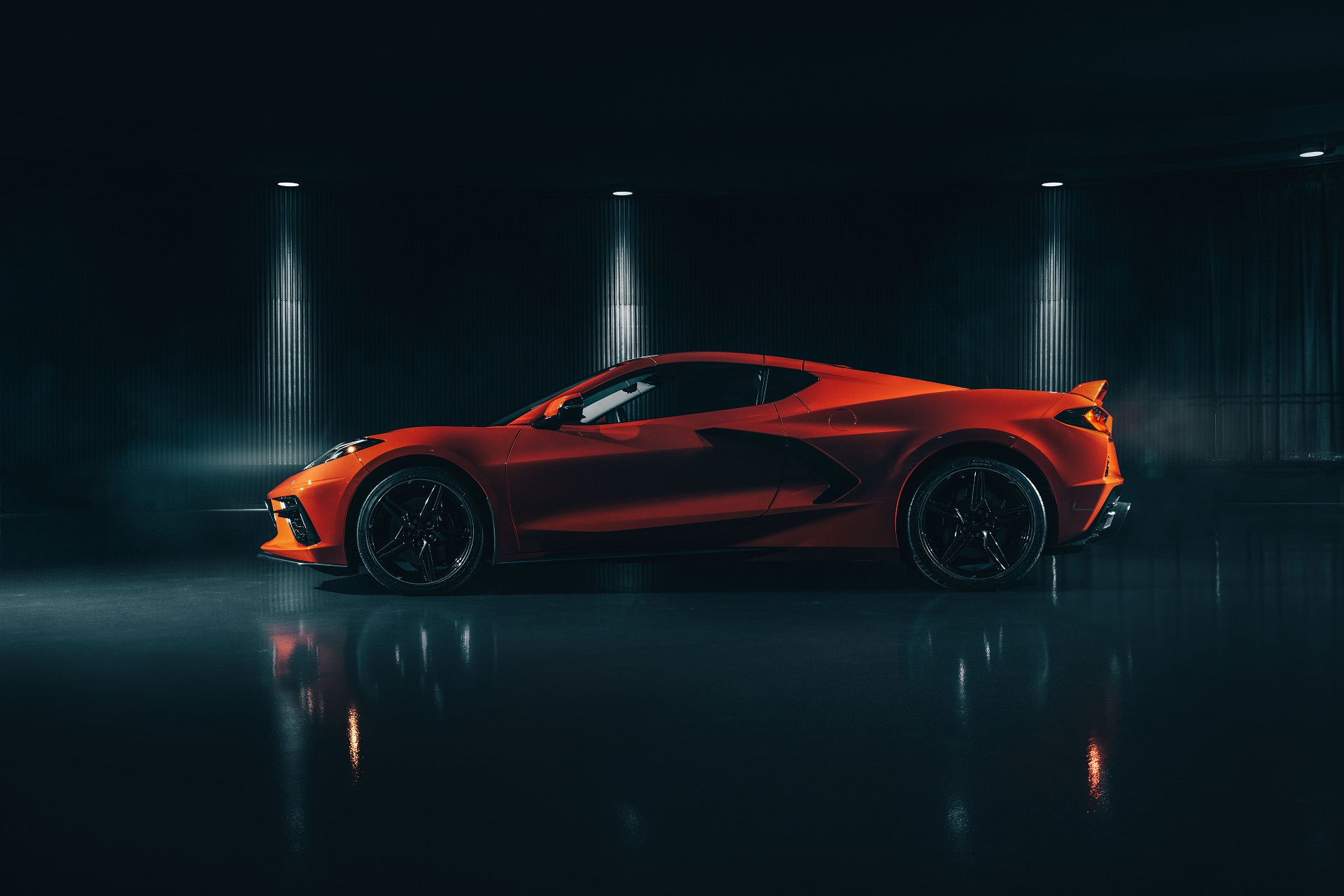 Side profile of an orange Chevrolet C8 Corvette