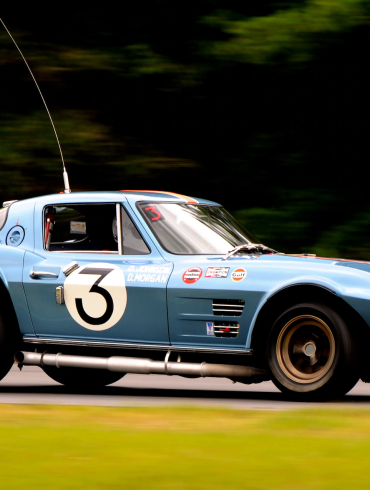 Side view of a 1963 Corvette Grand Sport at a racing track