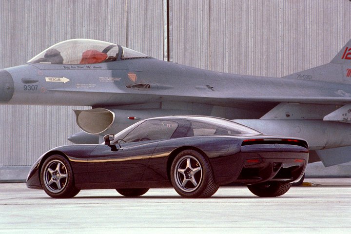 John Cafaro's Black Car, along Tom Peter's C5 styling buck, were presented for final review/selection at Selfridge Air National Guard Base in Macomb County, Michigan. Cafaro's concept was based on the C4’s birdcage chassis but featured a completely new and exciting look. Although both cars contributed to the final aesthetic found on the C5 Corvette, the Black Car featured much of the C5’s eventual design. (Image courtesy of GM Media.)